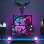 a desk with a monitor and speakers on it